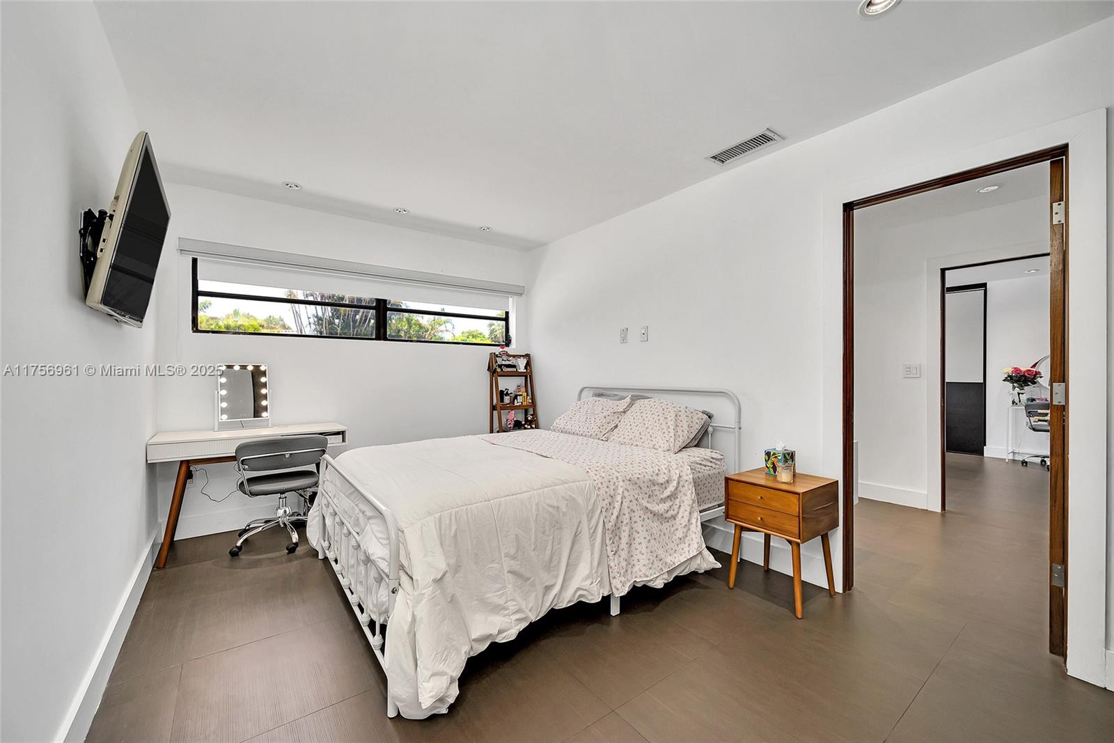 2120 Northeast 204th Street Miami, FL 33179 - Photo 27 of 52 a bedroom with a bed and a tv on table