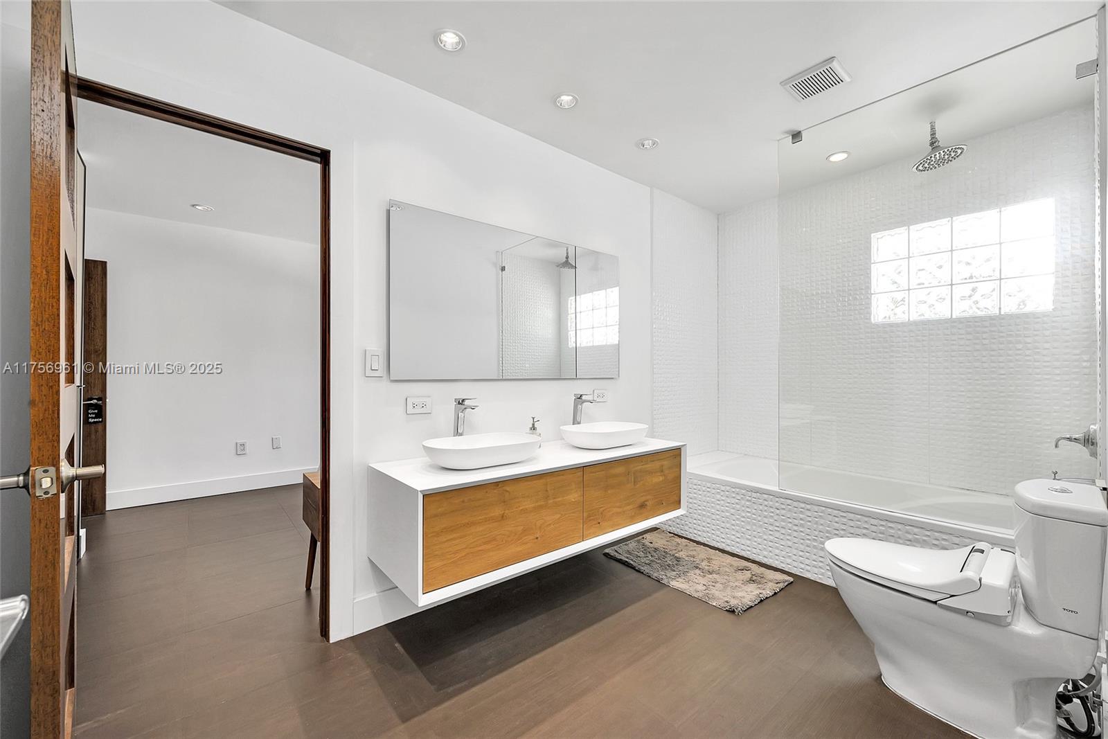 2120 Northeast 204th Street Miami, FL 33179 - Photo 29 of 52 a bathroom with a toilet a sink and a mirror