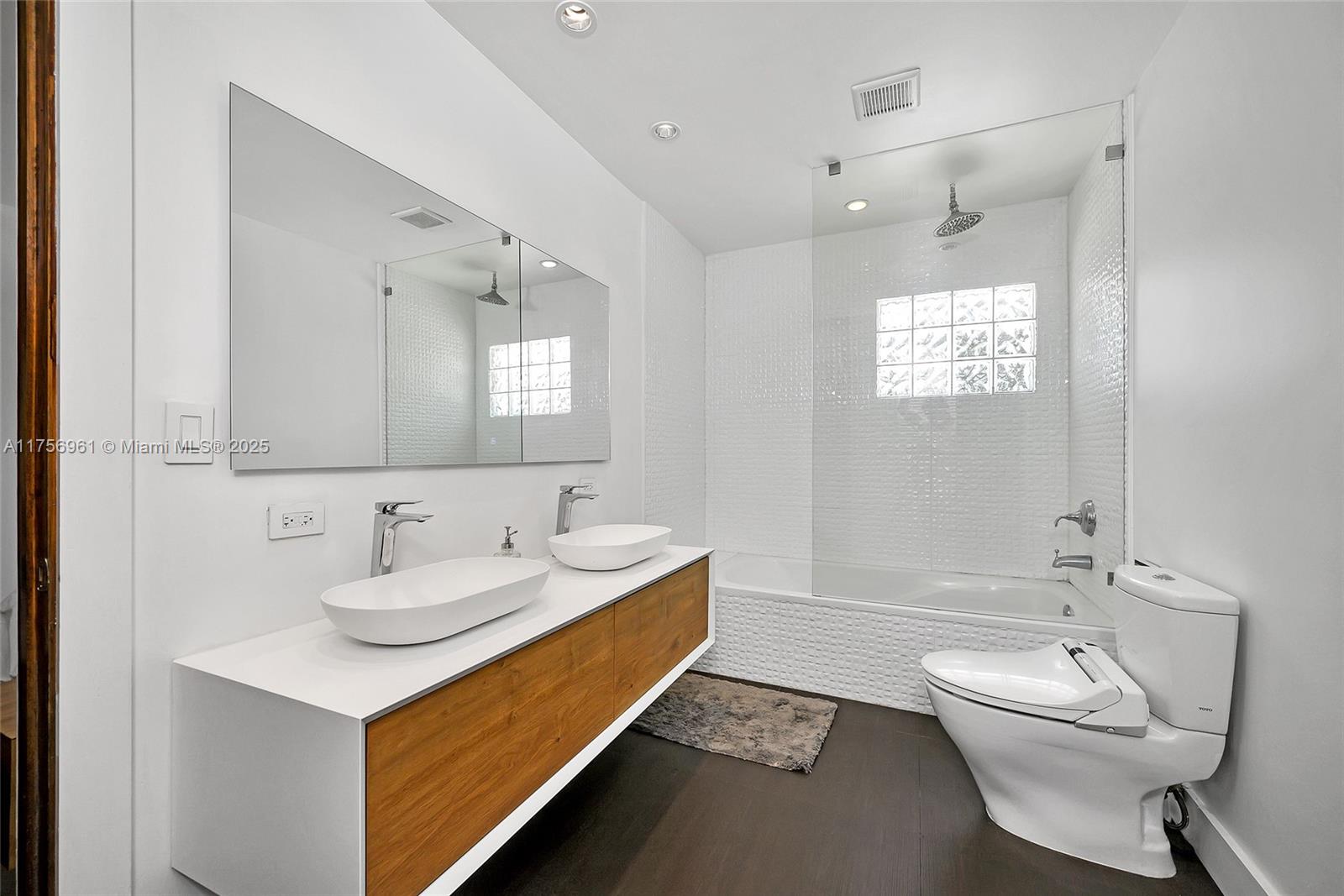 2120 Northeast 204th Street Miami, FL 33179 - Photo 30 of 52 a bathroom with a sink a toilet and tub