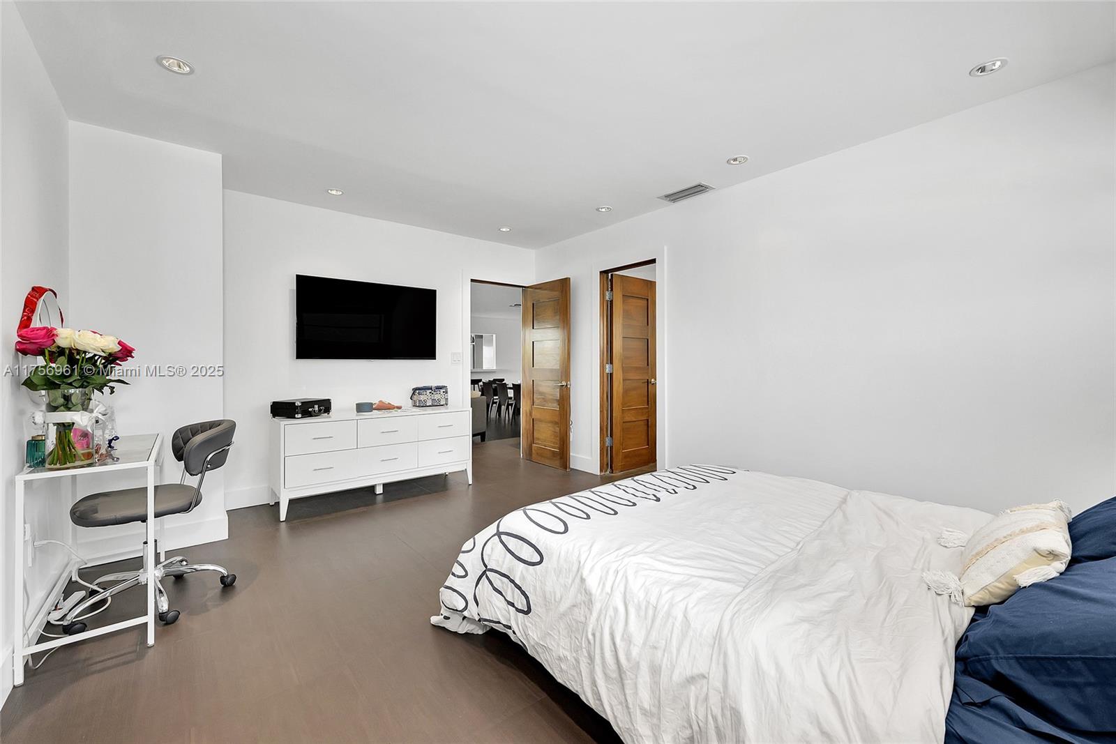 2120 Northeast 204th Street Miami, FL 33179 - Photo 32 of 52 a bedroom with a bed and a flat screen tv