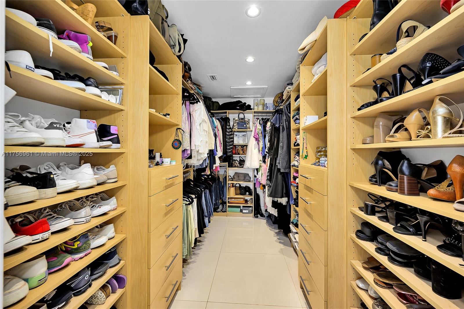 2120 Northeast 204th Street Miami, FL 33179 - Photo 35 of 52 a view of walk in closet with clothes and shoes