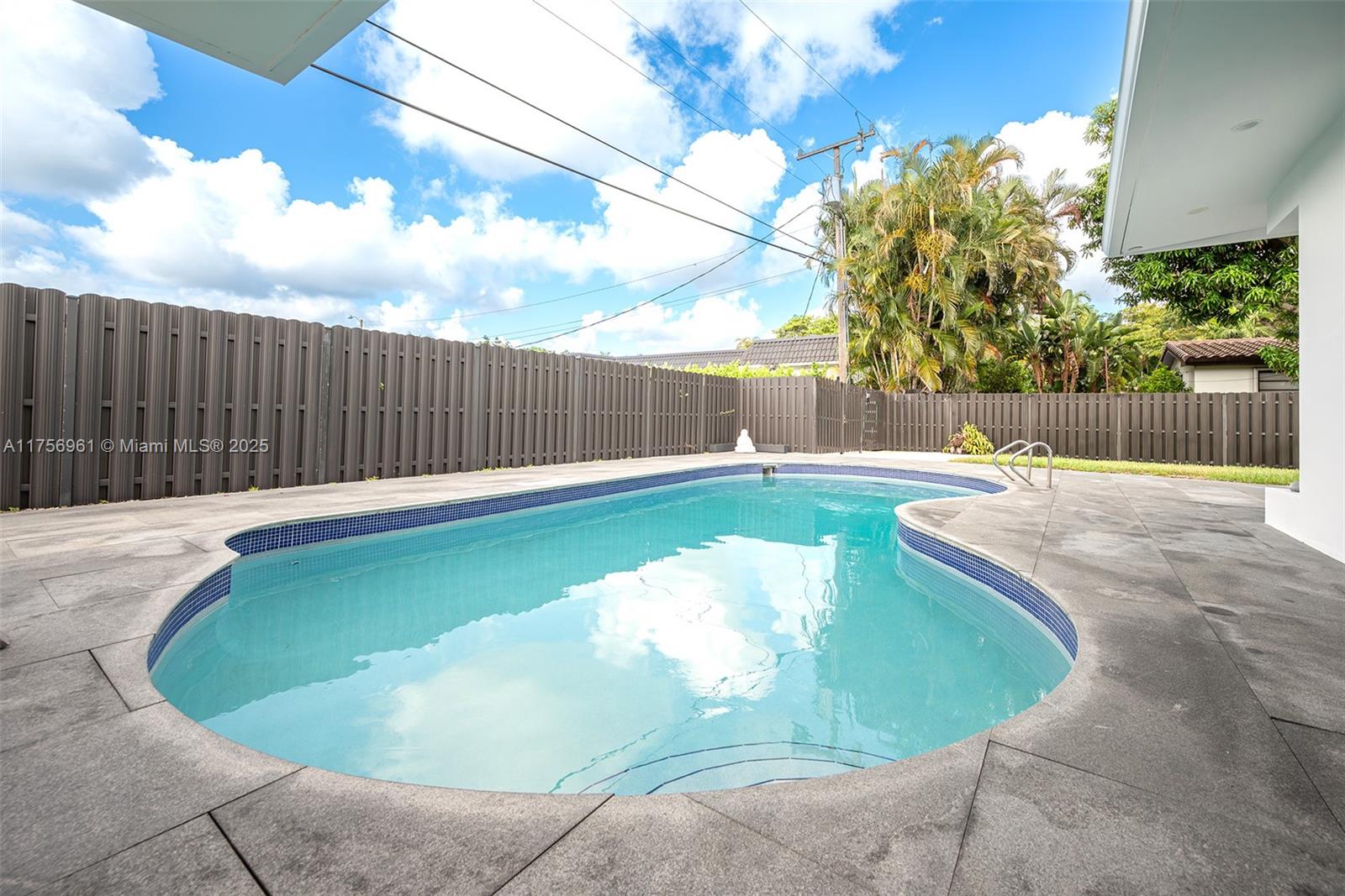2120 Northeast 204th Street Miami, FL 33179 - Photo 40 of 52 a swimming pool with wooden fence