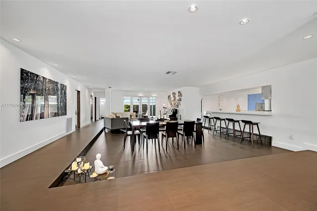 a living room with furniture and a dining table with kitchen view