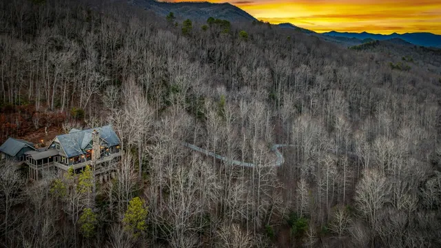 a view of a livingroom with furniture a fireplace and wooden floor
