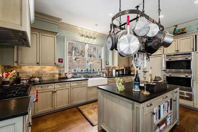 a view of a hallway with a livingroom and furniture