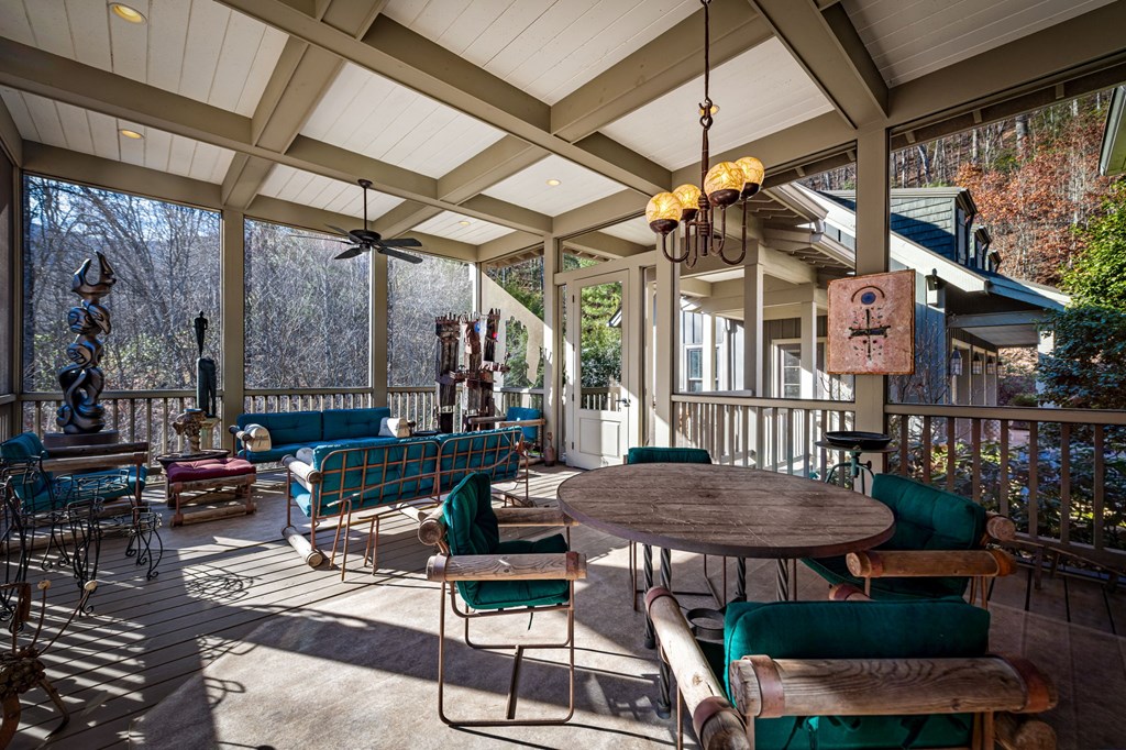 490 Red Wolf Run Franklin, NC 28734 - Photo 37 of 83 a view of a chairs and table in patio with a barbeque