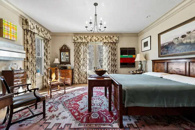 a living room with furniture a rug and a flat screen tv