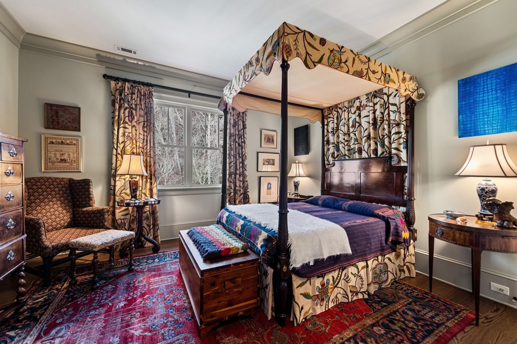 490 Red Wolf Run Franklin, NC 28734 - Photo 62 of 83 a bedroom with a bed a lamp and dresser next to a window