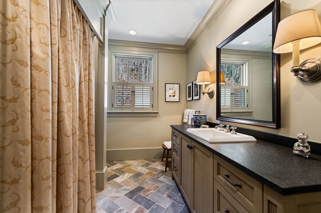 490 Red Wolf Run Franklin, NC 28734 - Photo 65 of 83 a bathroom with a sink a vanity and a mirror