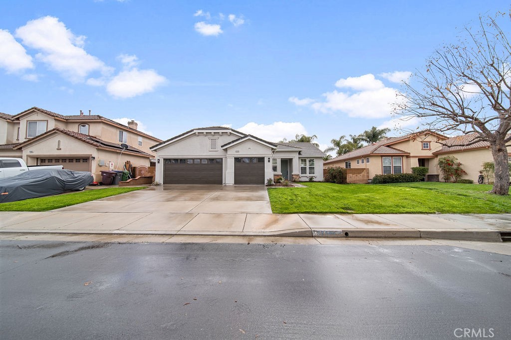a view of front of house with a yard and large trees