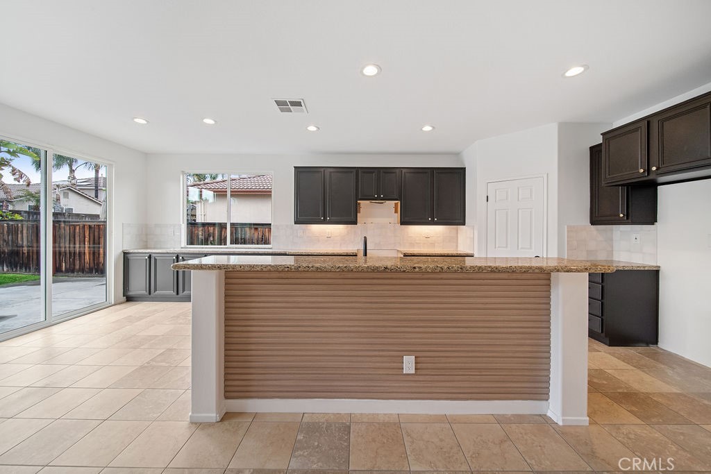 32591 Breton Drive Winchester, CA 92596 - Photo 15 of 21 a view of kitchen with stainless steel appliances wooden floor and living room