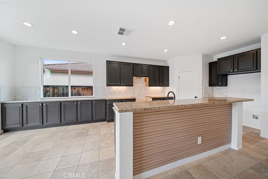 32591 Breton Drive Winchester, CA 92596 - Photo 19 of 21 a large white kitchen with a large window