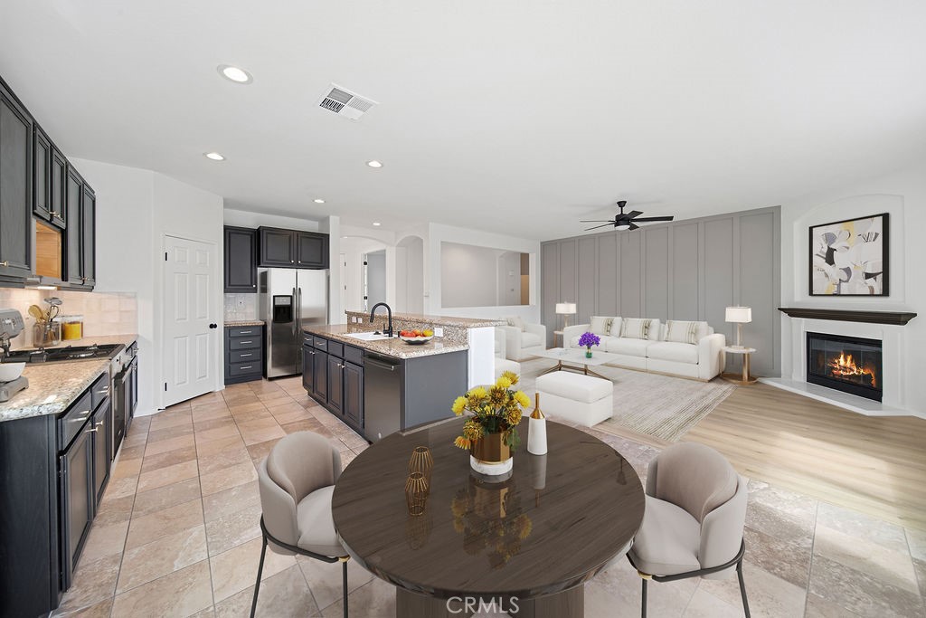 32591 Breton Drive Winchester, CA 92596 - Photo 6 of 21 a living room with fireplace furniture and a dining table with kitchen view