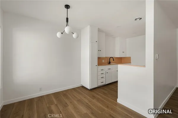 a kitchen with a refrigerator and stove top oven