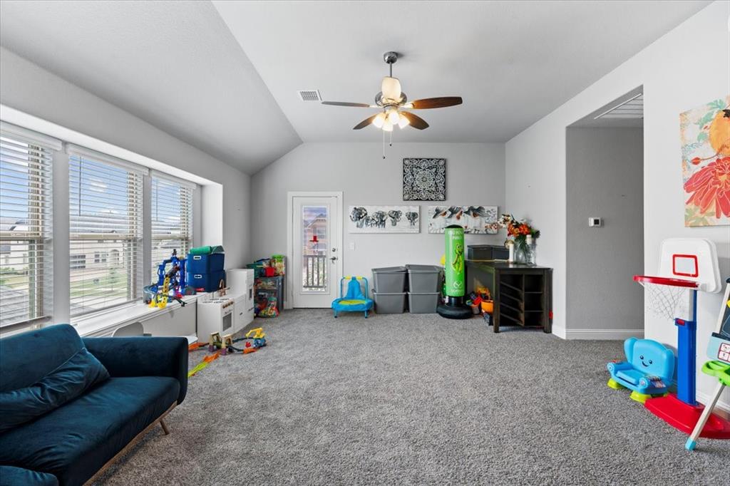 620 Shadow Trail Frisco, TX 75033 - Photo 23 of 36 Carpeted room featuring a vaulted ceiling and a ceiling fan