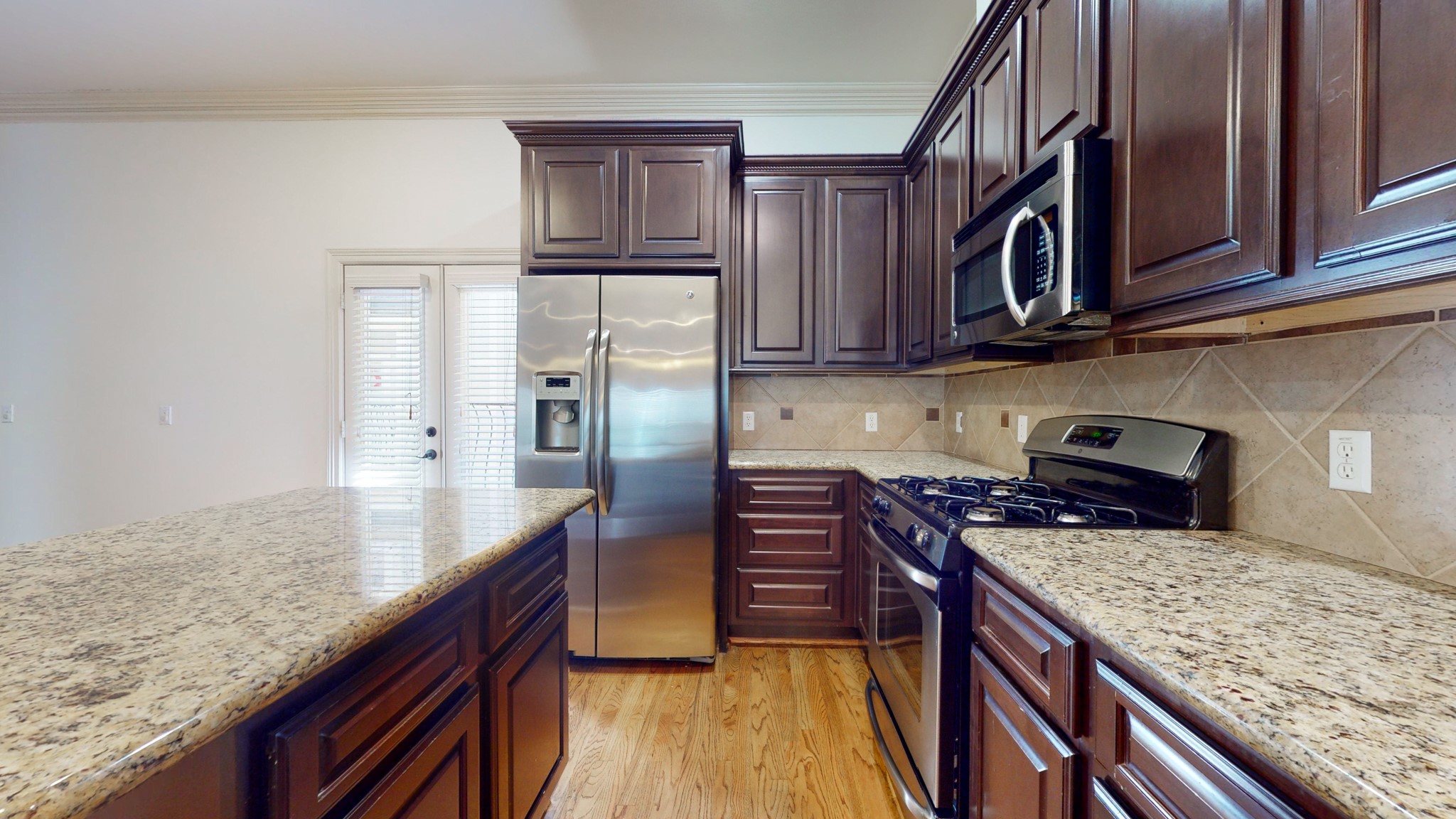 2540 Prospect Street, Unit B Houston, TX 77004 - Photo 5 of 18 a kitchen with stainless steel appliances granite countertop a refrigerator a stove and a sink