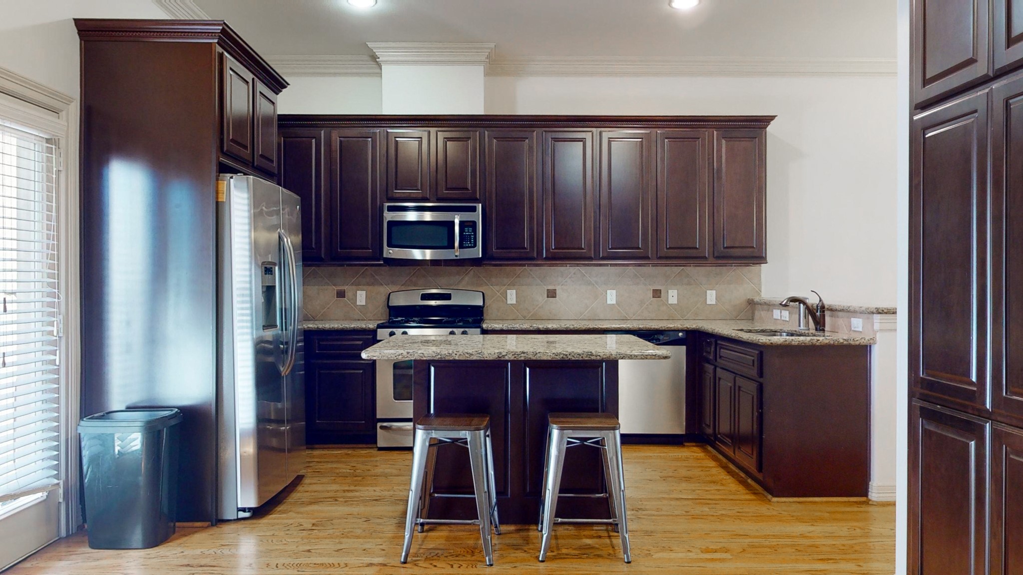 2540 Prospect Street, Unit B Houston, TX 77004 - Photo 6 of 18 a kitchen with stainless steel appliances granite countertop wooden cabinets a stove top oven a sink and dishwasher