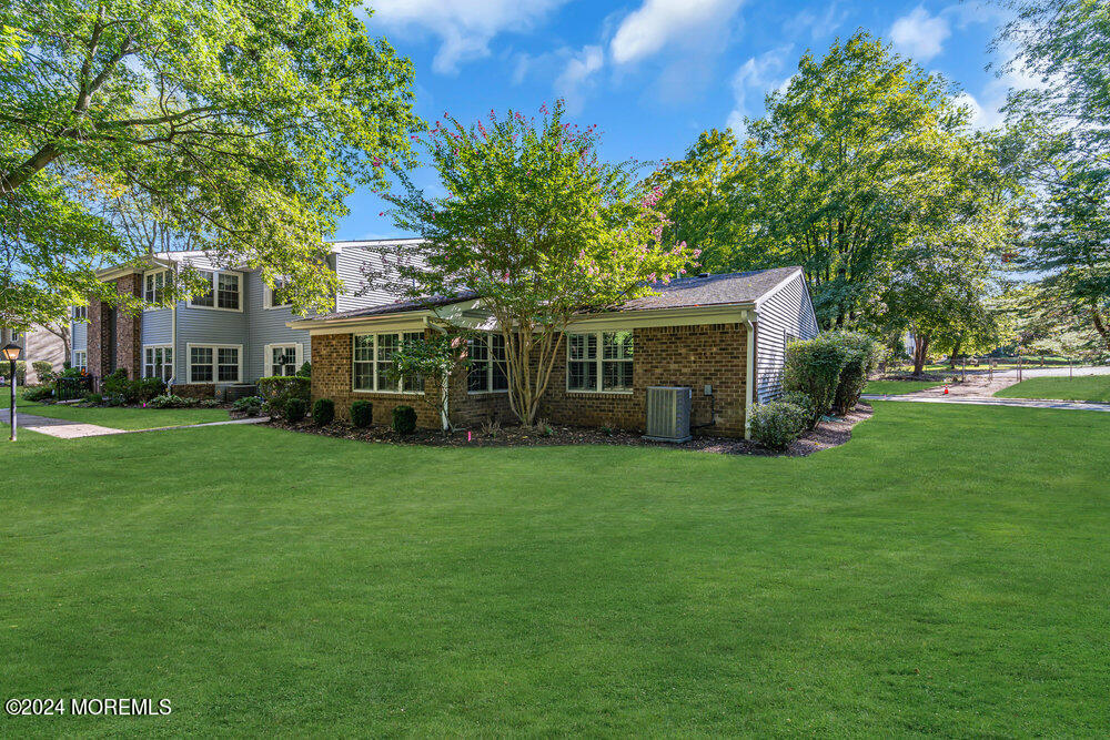 39 Firethorn Circle, Unit 339 Red Bank, NJ 07701 - Photo 11 of 16 a front view of a house with a garden