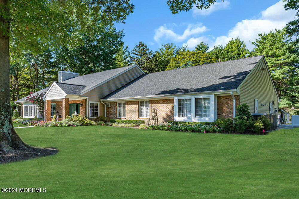 39 Firethorn Circle, Unit 339 Red Bank, NJ 07701 - Photo 12 of 16 a front view of a house with a garden