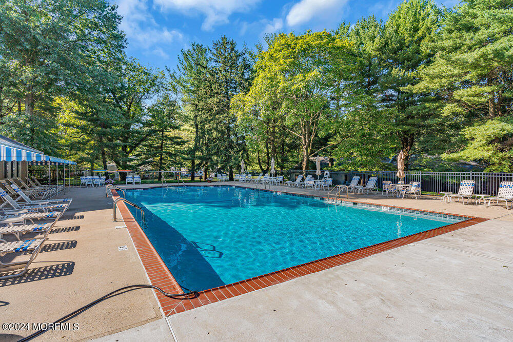 39 Firethorn Circle, Unit 339 Red Bank, NJ 07701 - Photo 15 of 16 a view of a pool with a yard