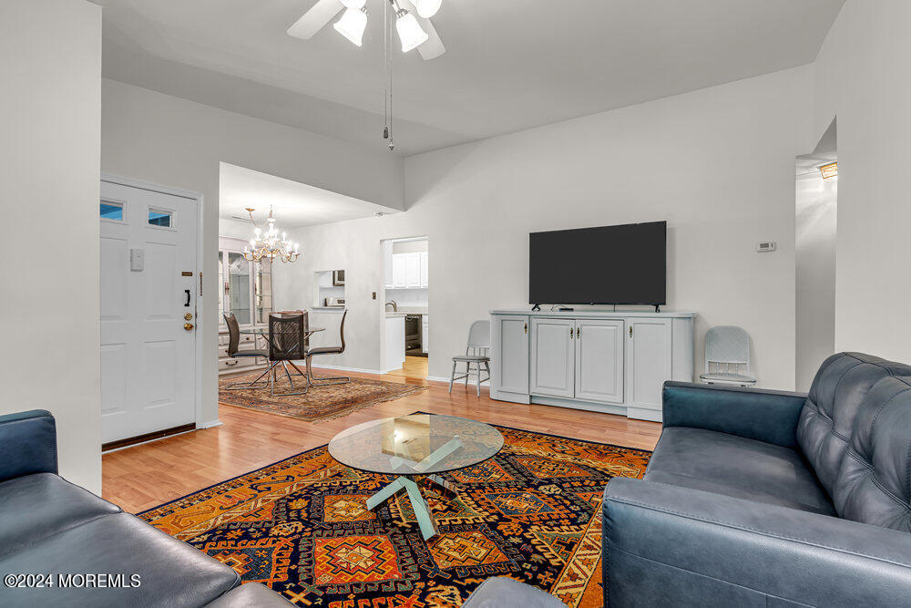 39 Firethorn Circle, Unit 339 Red Bank, NJ 07701 - Photo 2 of 16 a living room with furniture and a flat screen tv