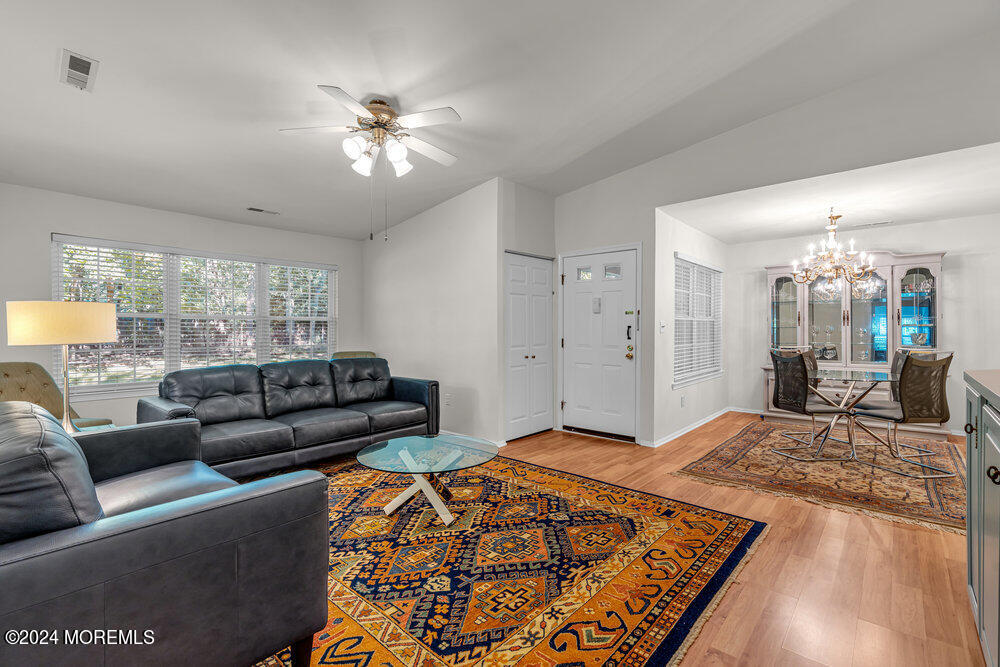 39 Firethorn Circle, Unit 339 Red Bank, NJ 07701 - Photo 3 of 16 a living room with furniture and a chandelier