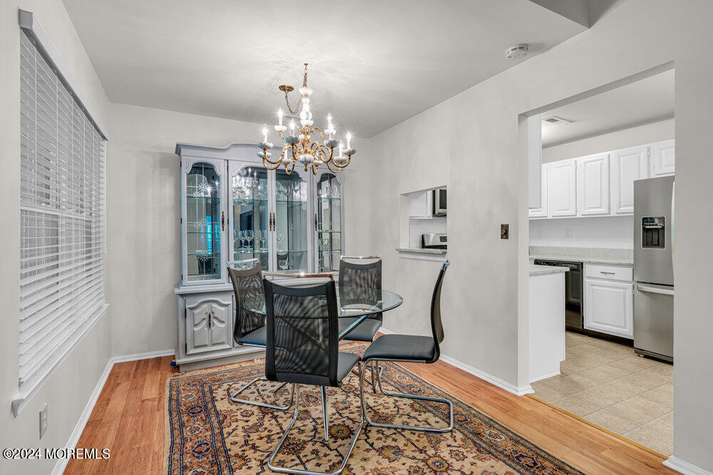39 Firethorn Circle, Unit 339 Red Bank, NJ 07701 - Photo 4 of 16 a view of a dining room with furniture and wooden floor