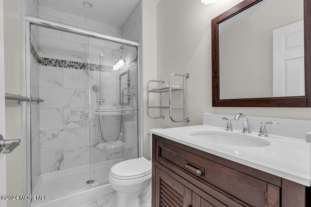 39 Firethorn Circle, Unit 339 Red Bank, NJ 07701 - Photo 7 of 16 a bathroom with a sink a toilet and shower