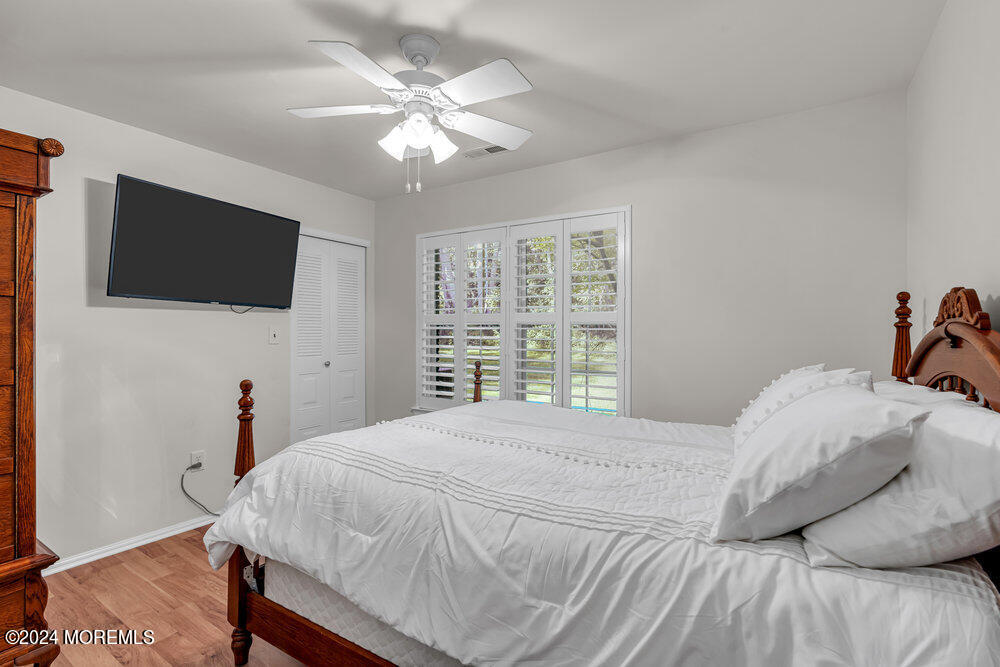 39 Firethorn Circle, Unit 339 Red Bank, NJ 07701 - Photo 8 of 16 a bedroom with a bed and a flat screen tv