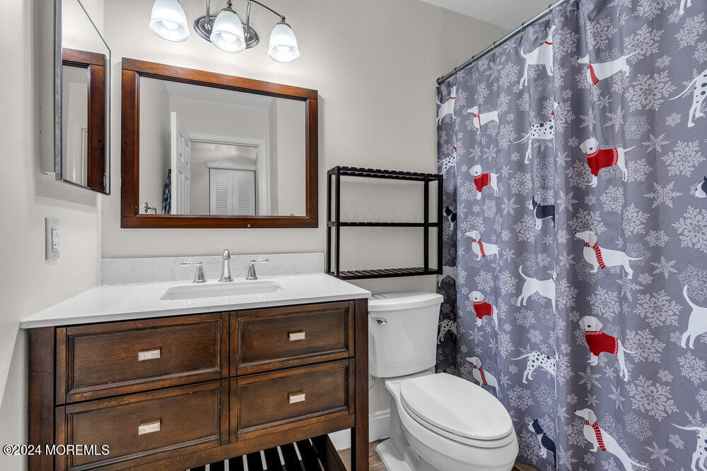 39 Firethorn Circle, Unit 339 Red Bank, NJ 07701 - Photo 9 of 16 a bathroom with a toilet sink vanity and mirror