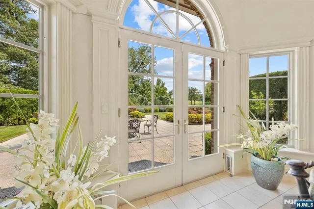 a living room filled with furniture and a potted plant