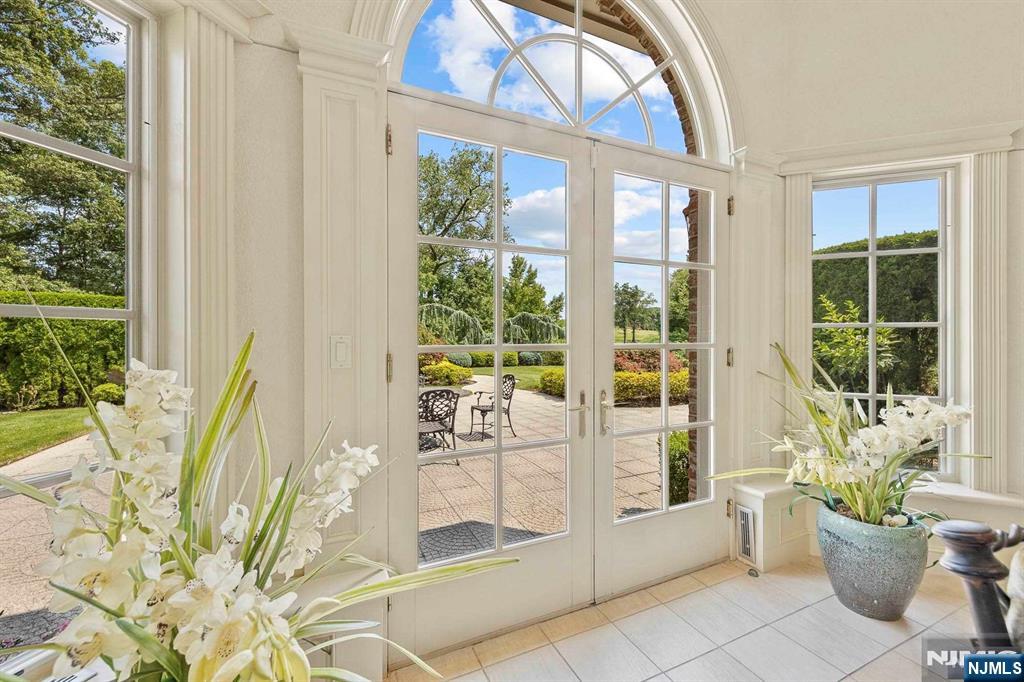 196 Vaccaro Drive Alpine, NJ 07620 - Photo 17 of 50 a living room filled with furniture and a potted plant