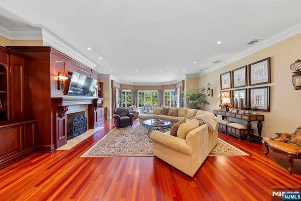 a living room with fireplace furniture and a large window