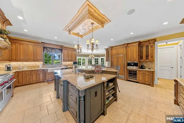 a kitchen with stainless steel appliances a dining table and chairs