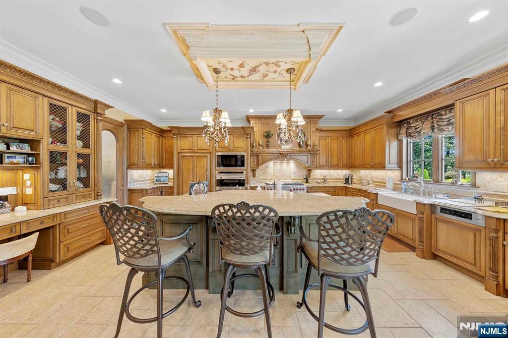 196 Vaccaro Drive Alpine, NJ 07620 - Photo 26 of 50 a kitchen with stainless steel appliances a dining table and chairs