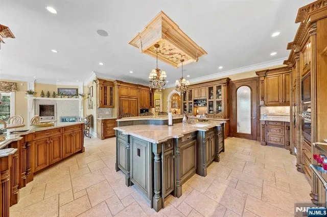 a large kitchen with stainless steel appliances granite countertop a large stove a sink and a refrigerator