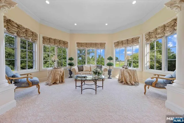 a living room with furniture and large windows