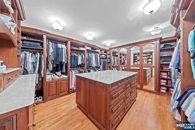 a kitchen with stainless steel appliances granite countertop a refrigerator a stove and a wooden floors