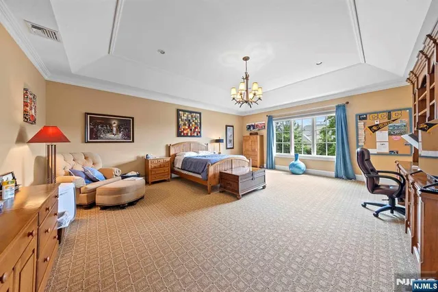 a bedroom with furniture and a chandelier