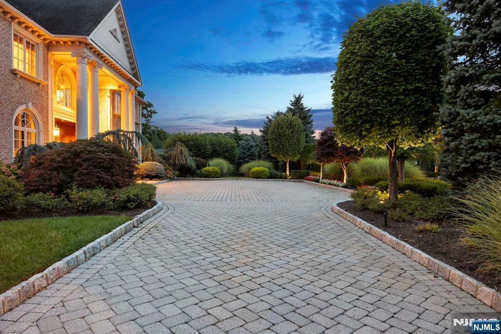 196 Vaccaro Drive Alpine, NJ 07620 - Photo 6 of 50 a view of a garden with plants and large trees