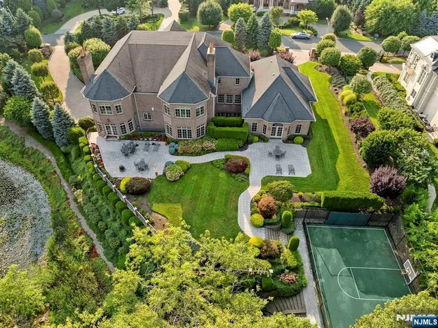 an aerial view of a house with swimming pool garden and mountain view