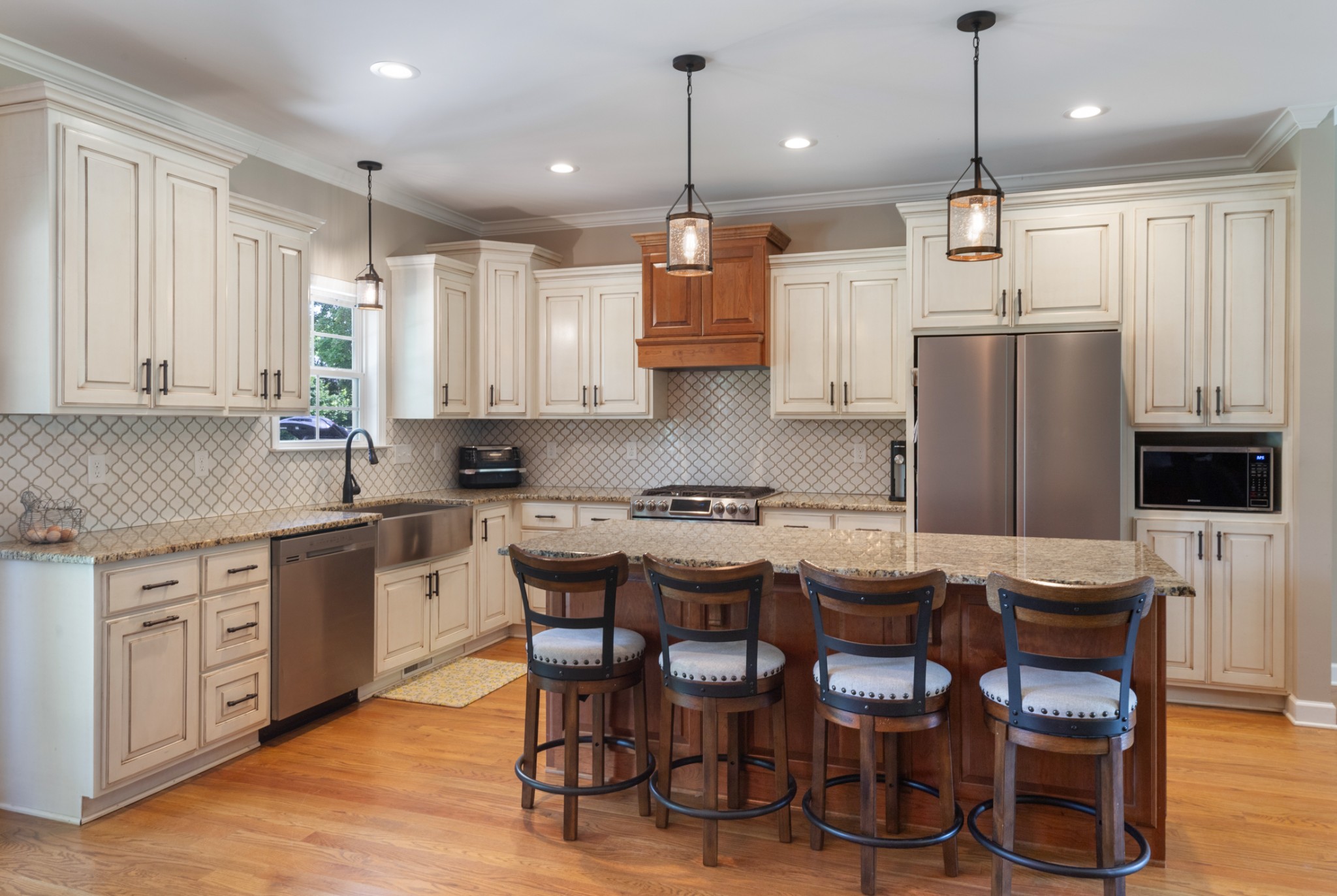 3215 Church Street Burns, TN 37029 - Photo 12 of 46 a kitchen with stainless steel appliances granite countertop a dining table chairs refrigerator and microwave
