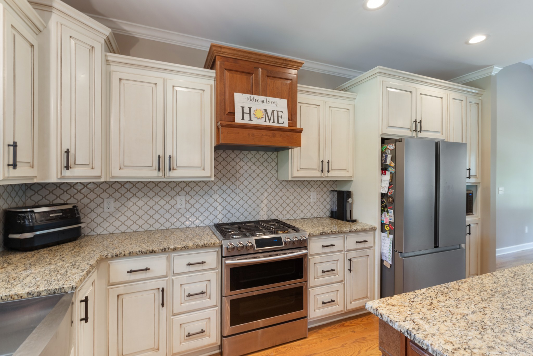 3215 Church Street Burns, TN 37029 - Photo 14 of 46 a kitchen with white cabinets and stainless steel appliances
