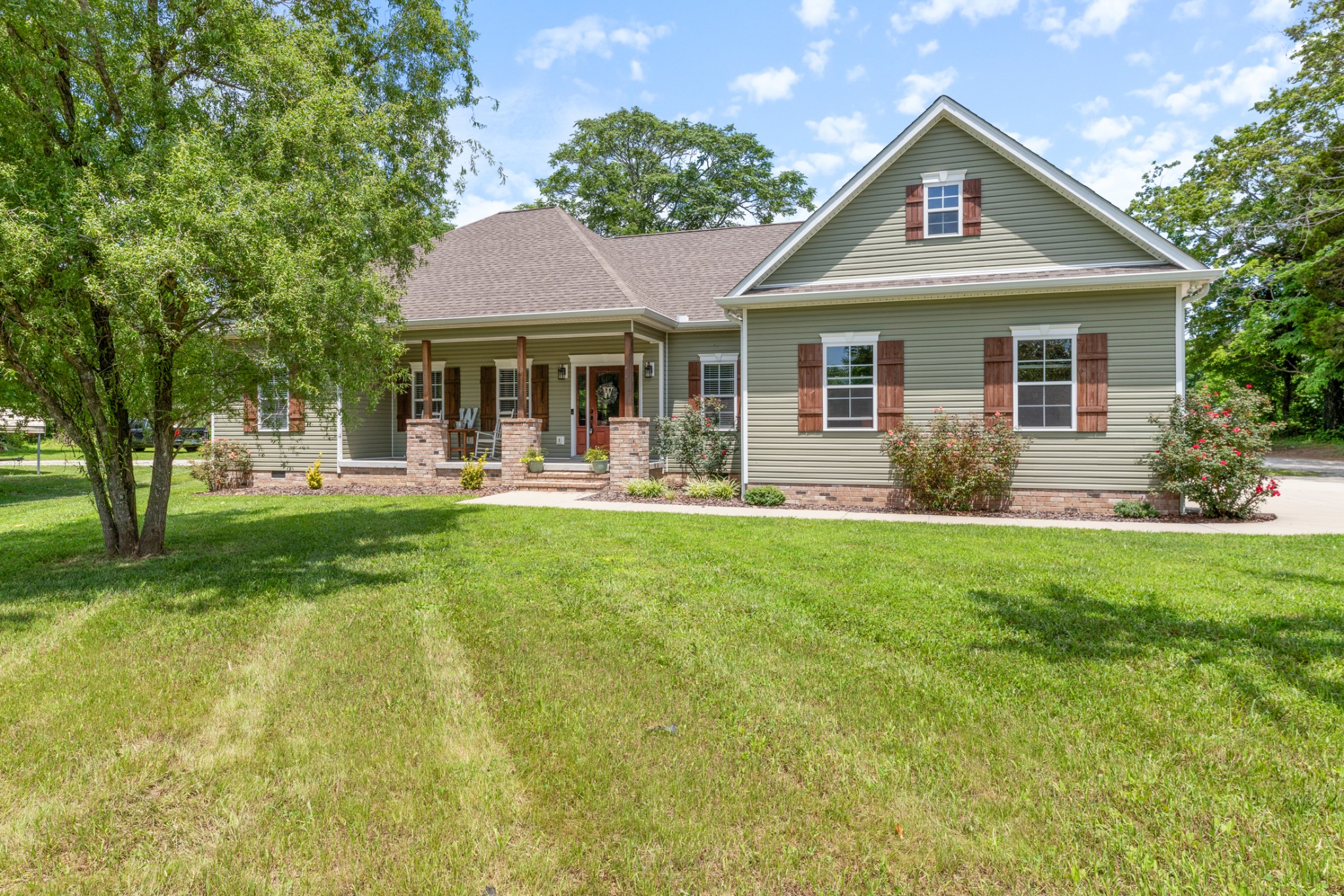 3215 Church Street Burns, TN 37029 - Photo 3 of 46 a front view of a house with a yard porch and outdoor seating