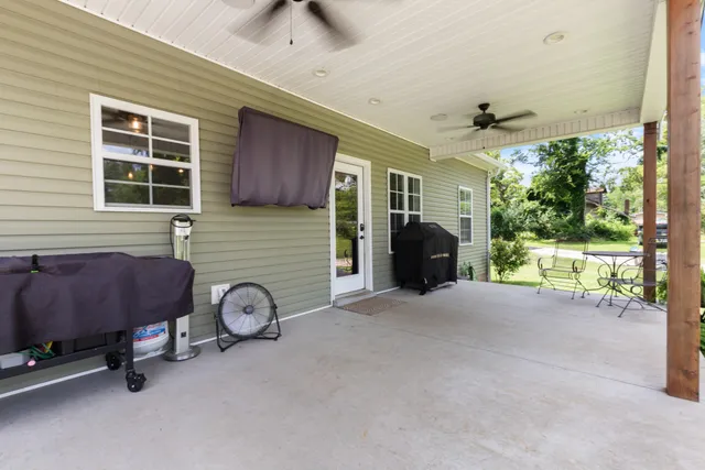 a view of a house with a yard patio and swimming pool