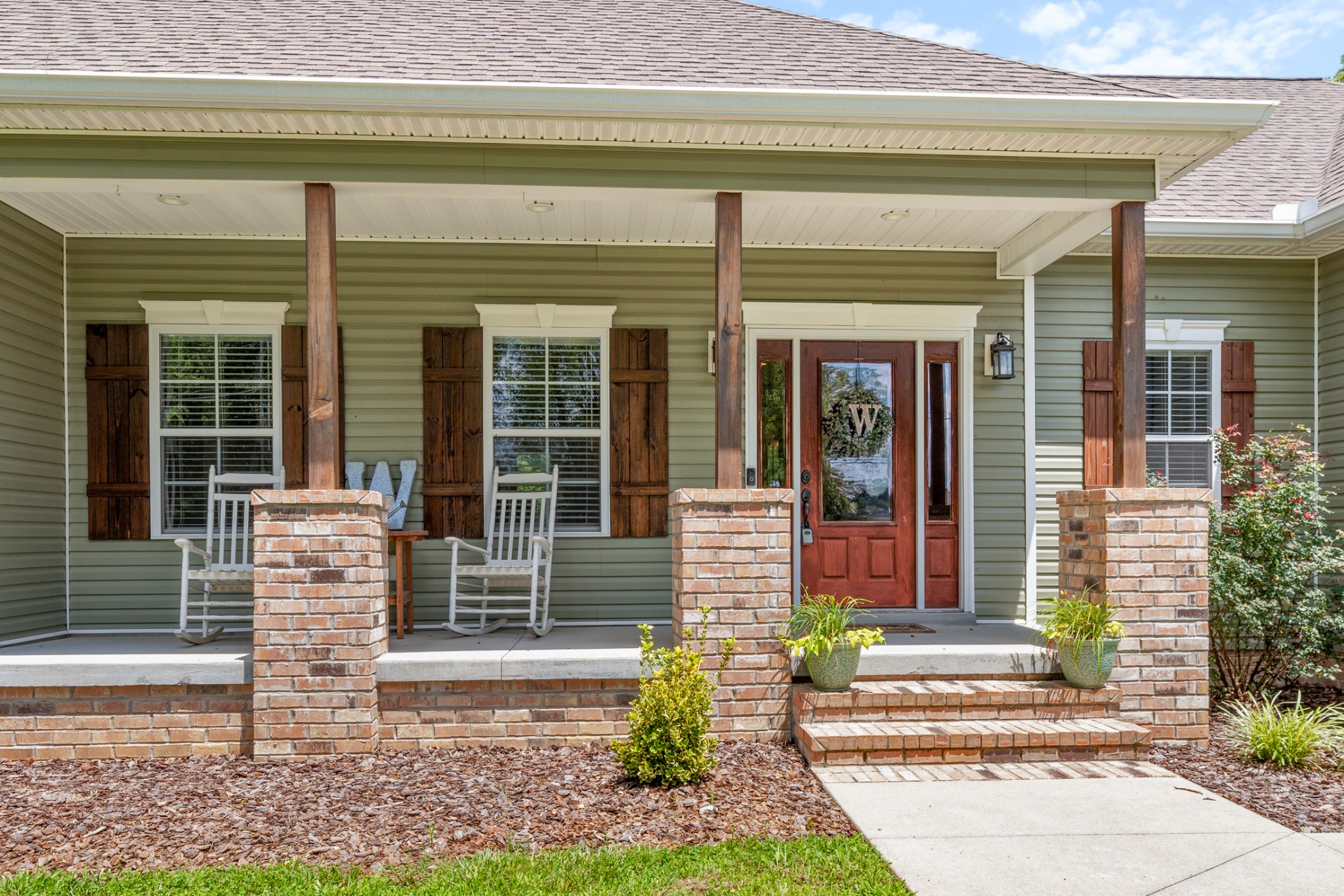 3215 Church Street Burns, TN 37029 - Photo 6 of 46 a front view of a house with a garden