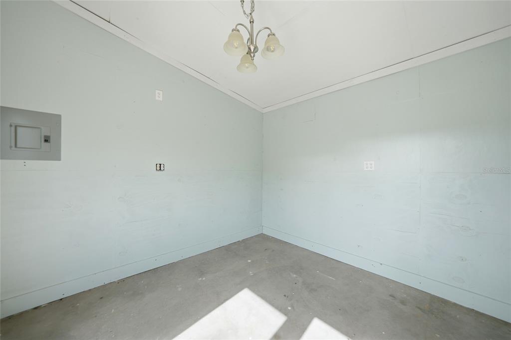 8164 Archie Street Englewood, FL 34224 - Photo 26 of 42 a view of a hallway with a chandelier fan
