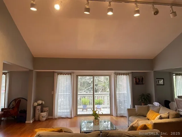 a living room with furniture and large windows