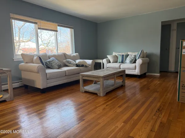 a living room with furniture and a wooden floor