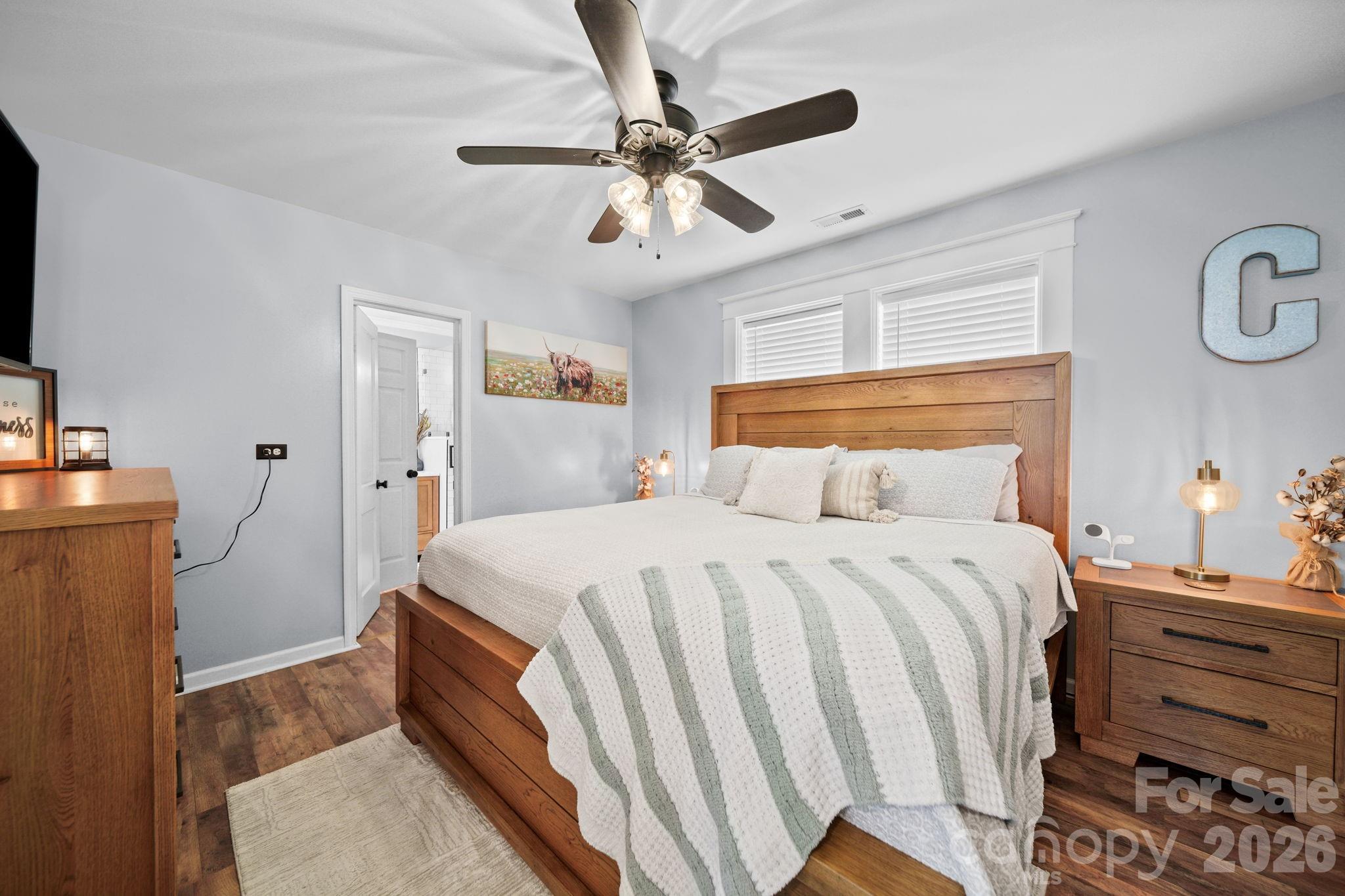 9215 Stokes Ferry Road Salisbury, NC 28146 - Photo 11 of 22 a bedroom with a bed and a chandelier
